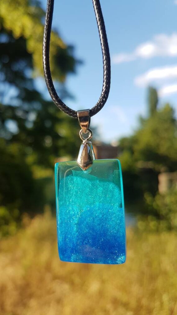 Black necklace with rectangular pendant made of epoxy resin - light blue sea from above