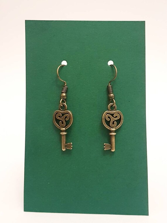 Earrings / ear pendants with Celtic decorated key in antique gold / antique bronze