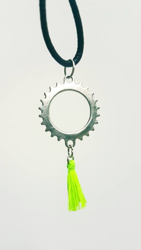 Black chain with silver gear and attached neon green tassel