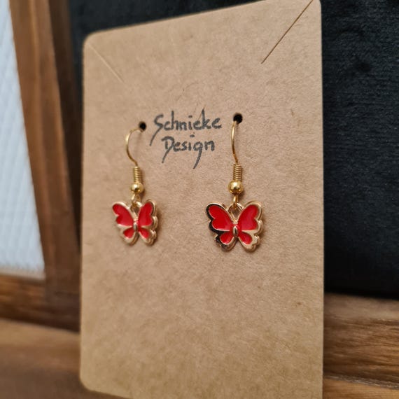 Golden earrings with small colorful butterflies