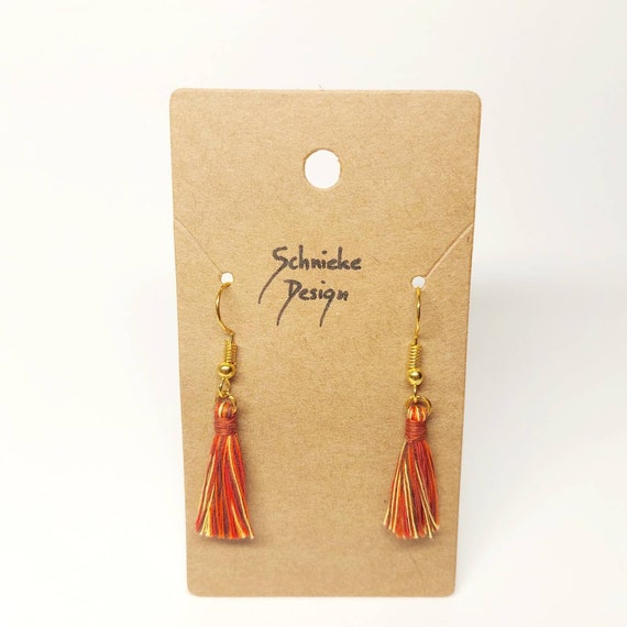 Earrings with small red tassels