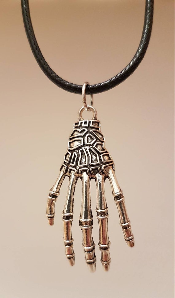 Black chain with large silver skeleton hand as pendant