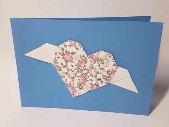 Blue folding card with origami heart with small roses and white wings