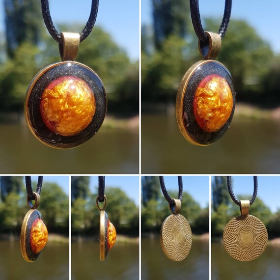 Necklace with handmade pendant made of epoxy resin - Round bronze-colored amulet with interior in metallic gold, red and black