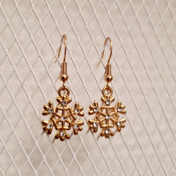 Winter earrings with gold and silver glittering snowflakes