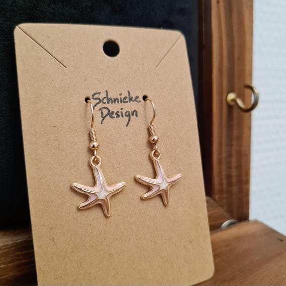 Earrings with starfish made of enamel