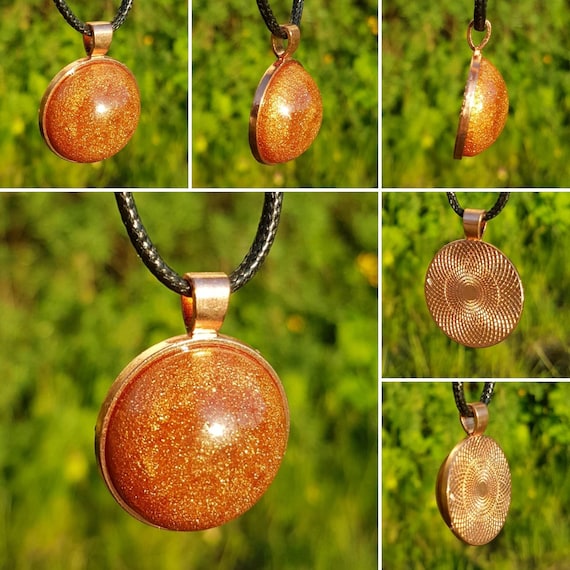 Necklace with round pendant: amulet in rose gold with semicircular filling in metallic bronze / copper made of epoxy resin