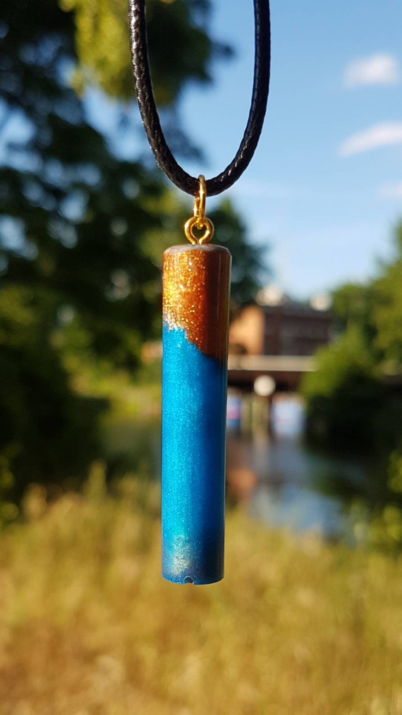 Necklace with pendant made of epoxy resin - metallic blue meets metallic gold - cylinder shape