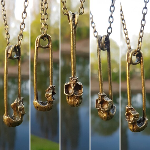 Black necklace with pendant: safety pin with skull / skull in antique gold / antique bronze