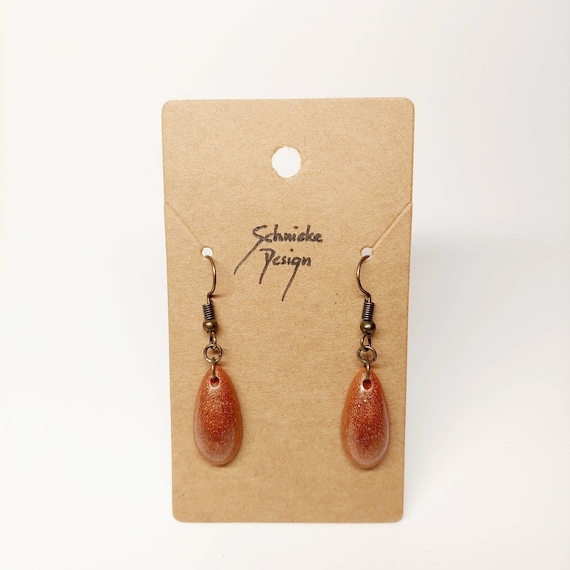 Earrings made of bronze epoxy resin in drop form