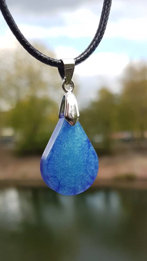 Necklace with drop-shaped pendant made of epoxy resin metallic: the depths of space in deep blue and purple with stardust