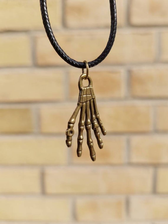 Black chain with a small bronze skeleton hand pendant