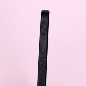 May include: Black phone case with a textured grip and a button on the side.