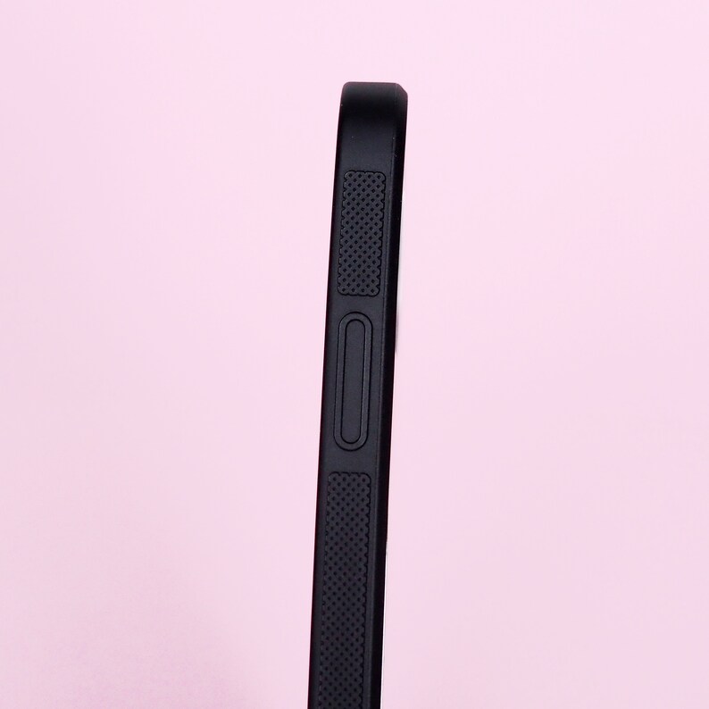 May include: Black phone case with a textured grip and a button on the side.