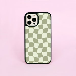 May include: A black phone case with a checkered pattern in shades of green and white. The case has a raised camera bump.