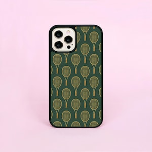May include: A green phone case with a pattern of gold tennis rackets. The case has a black border and a camera lens cutout.