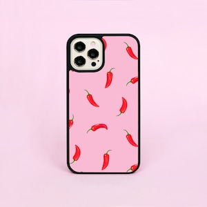 May include: A pink phone case with a black border and a pattern of red chilli peppers.