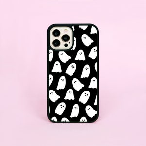 May include: Black phone case with a white ghost pattern.