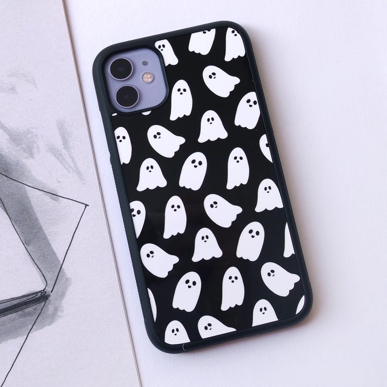 May include: Black phone case with a white ghost pattern.