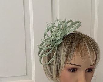 Sage green fascinator/hairband / comb, this style can be made in over 80 colours, contact me with the colour of your outfit for me to match