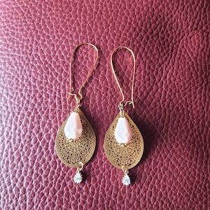 Earrings, large gold supports, gold filigree tears with ivory drops, small rhinestones under the filigree.