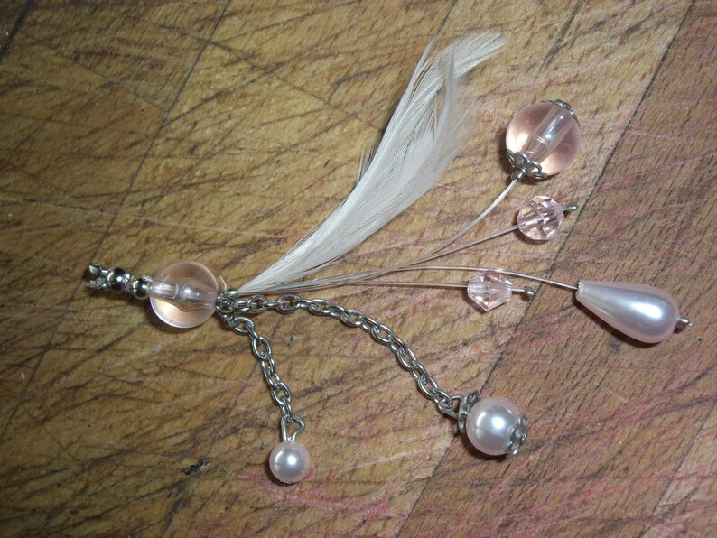Transparent pink beads and feather earrings
