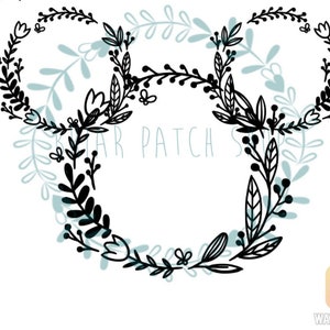 May include: Black floral wreath with two circles, resembling Mickey Mouse ears.