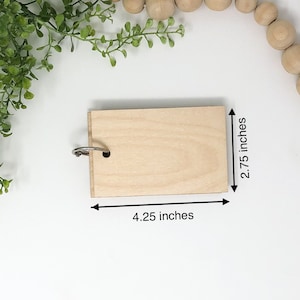 May include: A natural wood keychain with a metal ring. The keychain is 4.25 inches wide and 2.75 inches tall.
