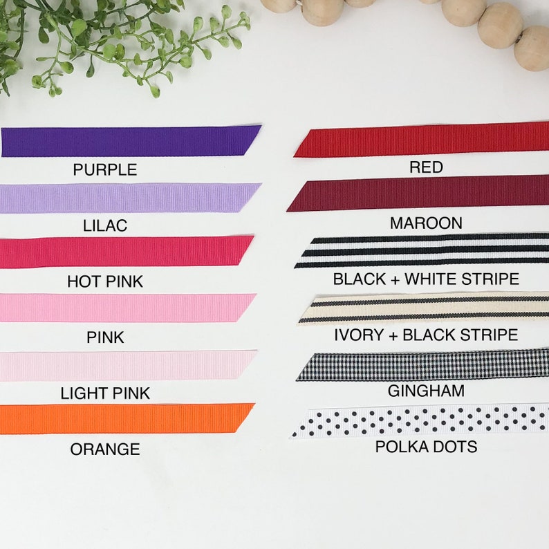 May include: A collection of ribbon samples in various colors and patterns, including purple, lilac, red, maroon, hot pink, pink, light pink, orange, black and white stripe, ivory and black stripe, gingham, and polka dots.