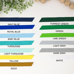 May include: A collection of ribbon samples in various colors, including navy blue, royal blue, baby blue, turquoise, light turquoise, yellow, gold, forrest green, green, lime green, light gray, dark gray, and white.