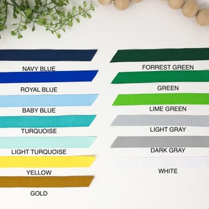 May include: A collection of ribbon samples in various colors, including navy blue, royal blue, baby blue, turquoise, light turquoise, yellow, gold, forrest green, green, lime green, light gray, dark gray, and white.