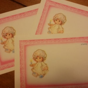 May include: Three blank cards with pink borders and a white interior. Each card features a small illustration of a girl in a nightgown holding a candle. The text "stamp" is printed in the bottom right corner of the card.