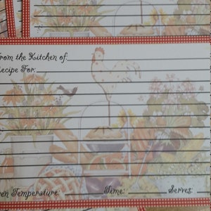May include: A set of recipe cards with a red and white checkered border. The cards feature a rooster illustration and a floral design. The cards have lines for writing down recipes, oven temperature, time, and servings.