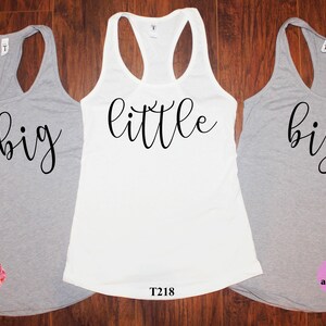 May include: Three gray tank tops with black text. The text on the left tank top says "g big", the middle tank top says "little", and the right tank top says "big".