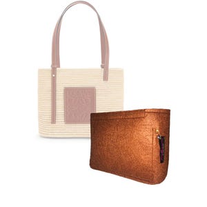 May include: A brown felt tote bag insert with a gold zipper pull. The insert is designed to fit inside a straw tote bag with a brown leather logo.