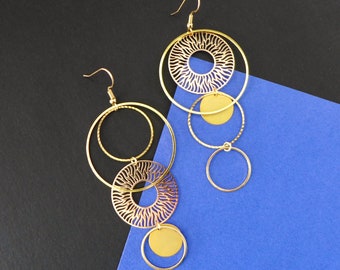 Golden earrings in asymmetrical round shapes, long and large mismatched earrings, long round golden earrings