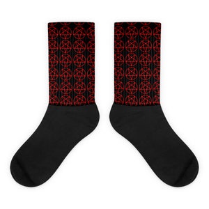 May include: A pair of black socks with a red pentagram pattern. The socks are made of a soft, comfortable material and are perfect for everyday wear.