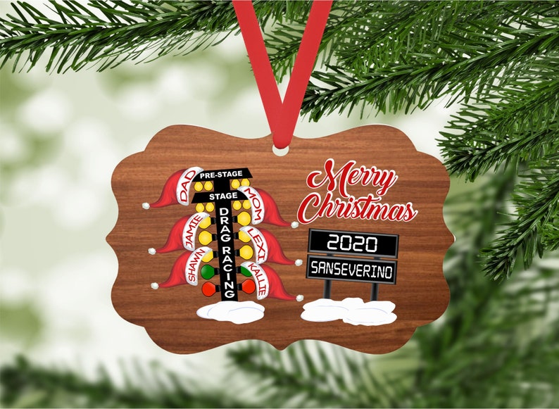 May include: A wooden Christmas ornament shaped like a drag racing Christmas tree with the words "Merry Christmas 2020 SANSEVERINO" on it.