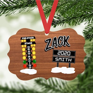 May include: A wooden Christmas ornament with a drag racing Christmas tree light and a personalized nameplate. The nameplate reads "ZACK 2020 SMITH".
