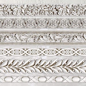 May include: A collection of white decorative molding strips with various floral and leaf patterns. The designs include roses, stylized flowers, and symmetrical leaf arrangements, suitable for interior design or craft projects.