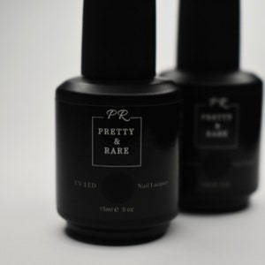 May include: Two black bottles of nail polish with the text "PR PRETTY & RARE" and "UV LED Nail Lacquer 15ml e .5 oz" on the label.