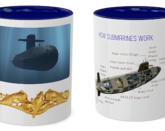 May include: A white ceramic coffee mug with a blue rim and handle. The mug features a gold submarine emblem on the front and a humorous illustration of a submarine with the text "HOW SUBMARINES WORK" on the back.
