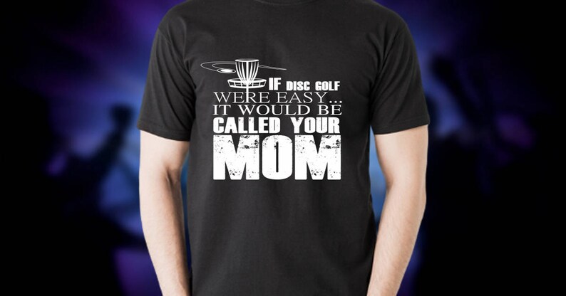 May include: Black t-shirt with a white graphic of a disc golf basket and the text "If disc golf were easy... it would be called your mom."