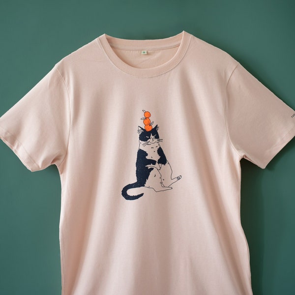 Orange Cat t-shirt | Hand screen printed illustration of a cat balancing oranges on misty pink organic cotton tee with navy and orange