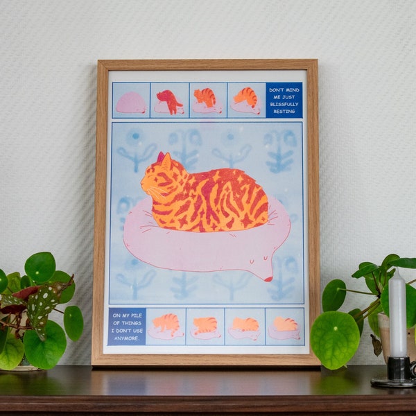 Bliss A3 Risograph poster | Illustration in magenta, light fluor orange and blue of a comic style illustration of a tabby cat getting comfy