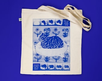 Bliss Tote Bag | Hand screen printed on natural organic cotton tote with blue comic style illustration of a tabby cat getting comfy
