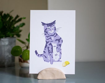 Sour Puss | Art print of a digital drawing featuring a purple tabby cat reacting to a lemon with a funny expression