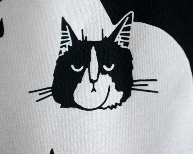 Rain Cloud Cat T-Shirt Hand screen printed on black organic cotton tee with white illustration of a not amused cat in a costume image 3