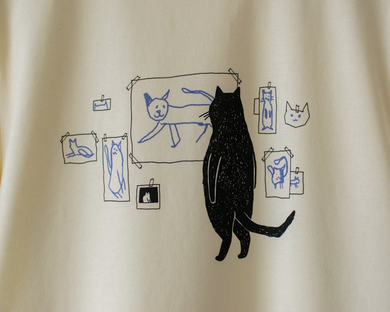 Cat gallery t-shirt Hand screen printed on ecru/light yellow organic cotton tee with black and blue illustration of a cat judging cat art image 2