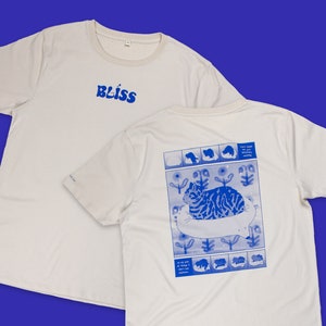 Bliss t-shirt | Hand screen printed on sand/beige organic cotton tee with blue comic style illustration of a tabby cat getting comfy